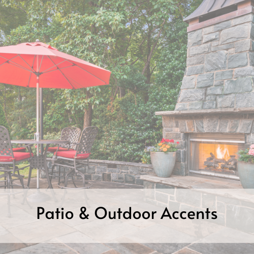 Patio table with umbrella adjacent to outdoor stone fireplace.