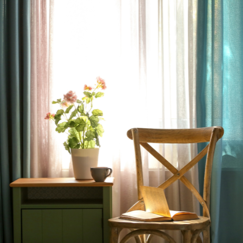 Image of a window with layered curtains illustrating a potential DIY home upgrade to the reader. 