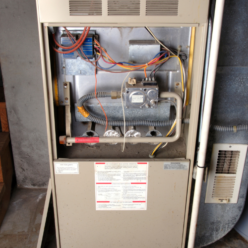 Furnace with open cover so HVAC technician can perform a fall inspection.